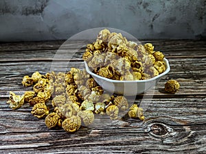 Popcorn is a variety of corn kernel which expands and puffs up when heated.